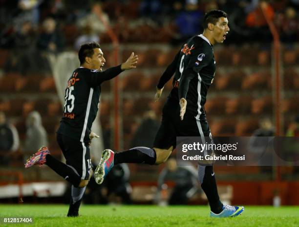 Oscar Cardozo of Libertad celebrates with teammate Angel Cardozo Lucena after scoring the opening goal of his team during a first leg match between...