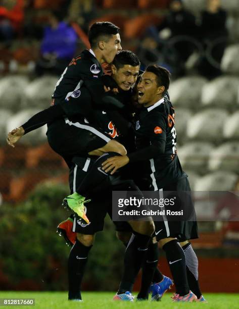 Oscar Cardozo of Libertad celebrates with teammates Angel Cardozo Lucena and Antonio Bareiro after scoring the opening goal of his team during a...