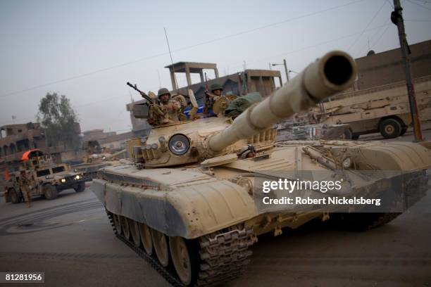 An Iraqi Army T-72 tank waits to cross the concrete barrier dividing Sadr City to take control of the 2.5 million Shia dominated stronghold of cleric...