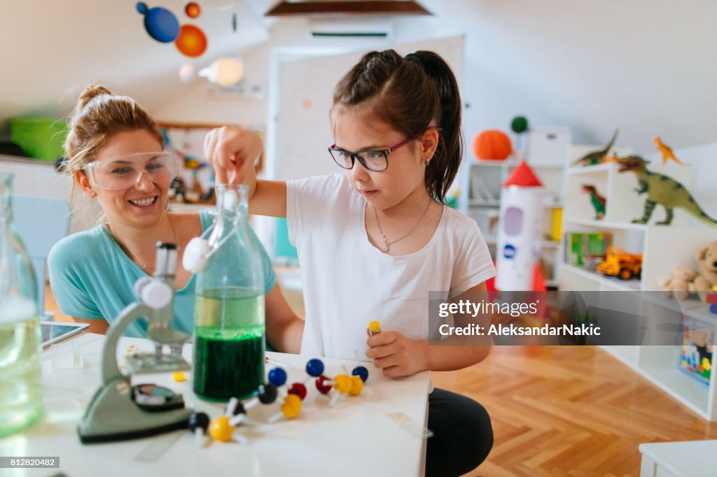Girl and her mother doing scientific experiment