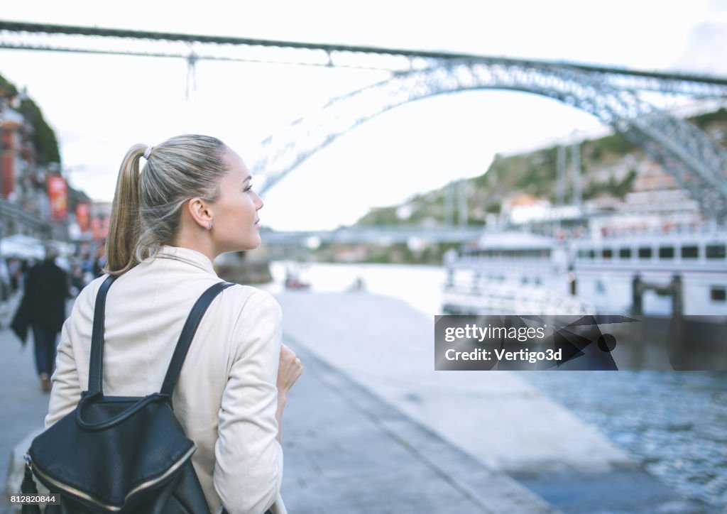 Young woman with backpack walking on the european streets