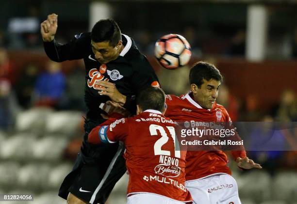 Oscar Cardozo of Libertad heads the ball to score the opening goal of his team during a first leg match between Huracan and Libertad as part of...