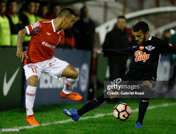 Alejandro Romero Gamarra of Huracan fights for the ball with Antonio Bareiro of Libertad during a first leg match between Huracan and Libertad as...