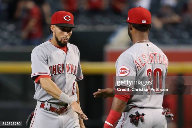 Billy Hamilton of the Cincinnati Reds high fives Arismendy Alcantara after defeating the Arizona Diamondbacks in the MLB game at Chase Field on July...