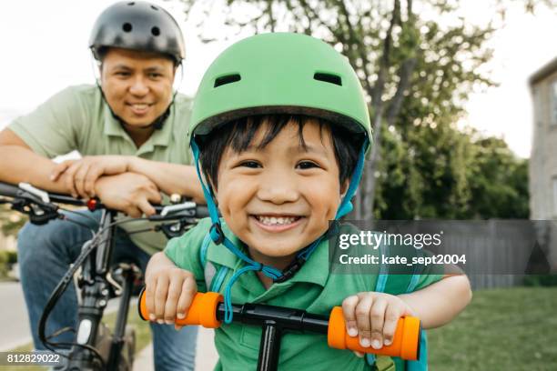 padre e hijo en bicicleta - inmigrantes fotografías e imágenes de stock