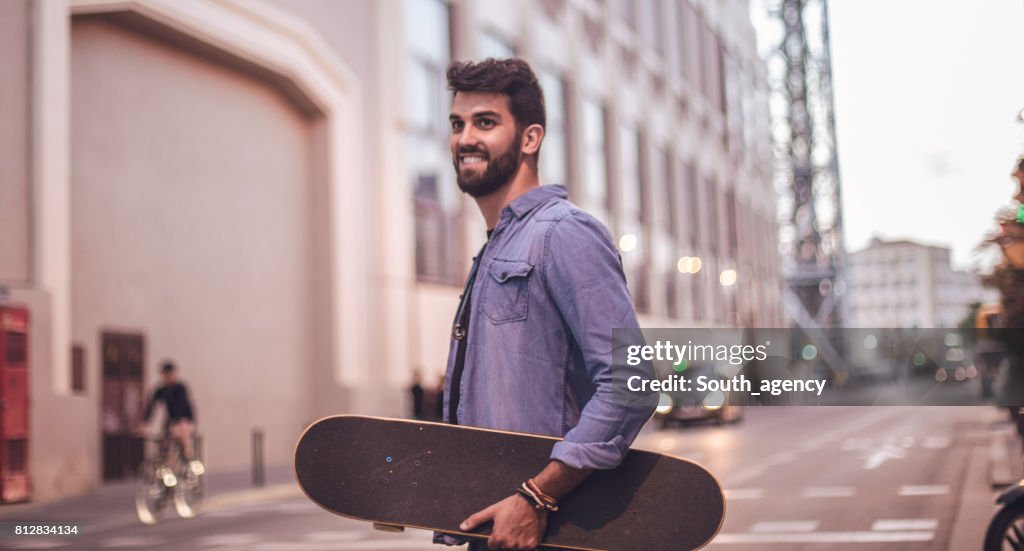 Handsome skater in city