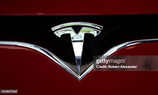 The Tesla brand logo embellishes the nose of a Tesla electric sedan in Vail, Colorado.