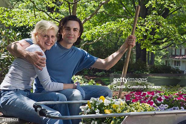 happy couple in garden - bollerwagen mann stock-fotos und bilder