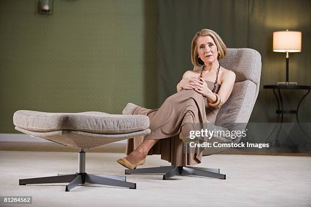 woman relaxing at home - 50 59 years home stock pictures, royalty-free photos & images