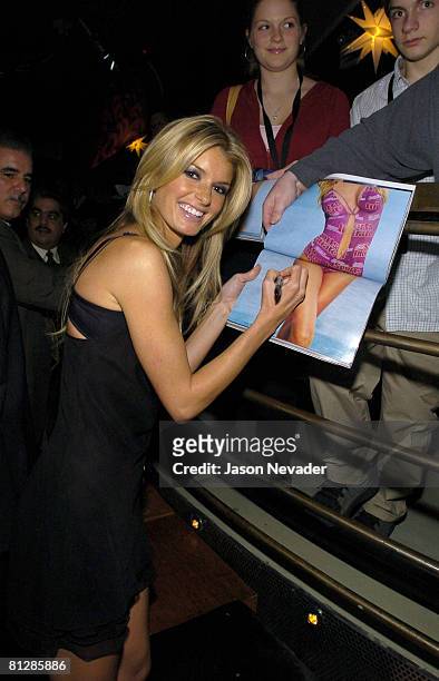 Marisa Miller signs her autograph for a fan