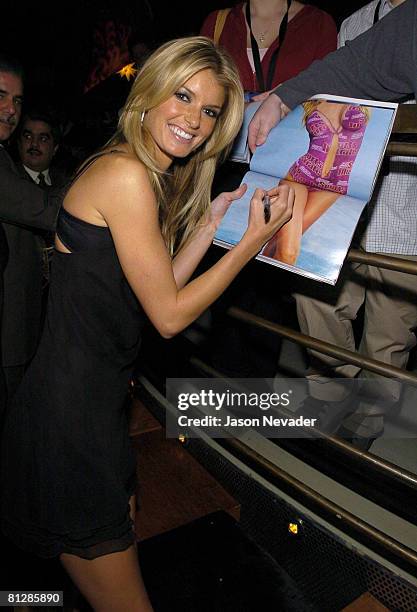 Marisa Miller signs her autograph for a fan