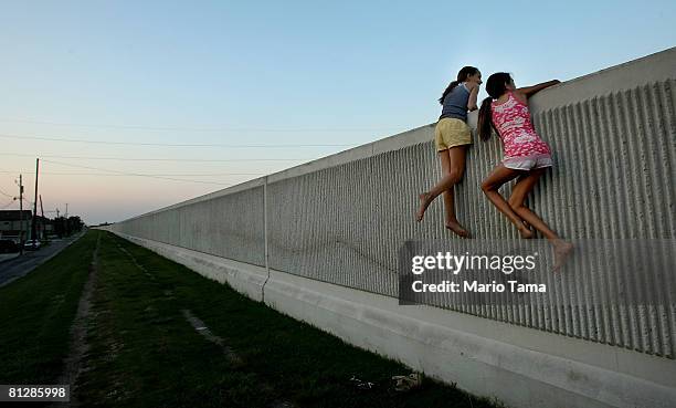 Isabella Lander and Arabella Christiansen climb on the 17th Street Canal levee May 29, 2008 in Metairie, Louisiana. Despite $22 million in repairs,...