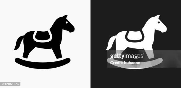 horse rocker icon on black and white vector backgrounds - white horse on black background stock illustrations