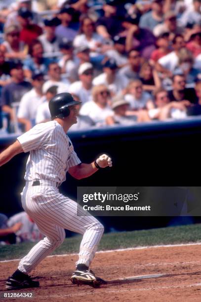 Paul O'Neill of the New York Yankees swings at the pitch during an MLB game against the Texas Rangers on August 15, 1998 at Yankee Stadium in the...