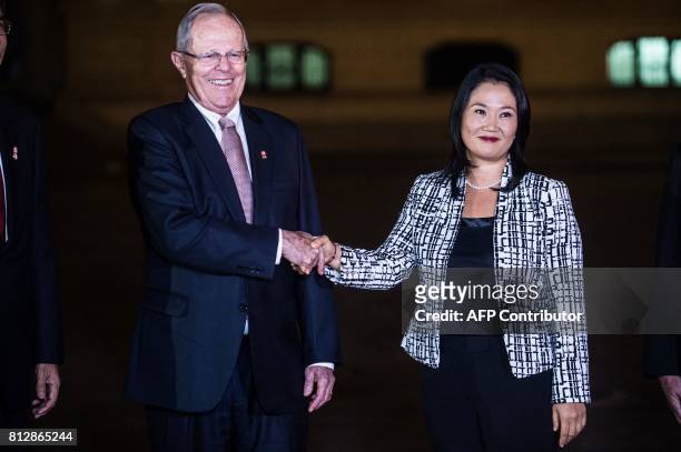 Peru's President Pedro Pablo Kuczynski shakes hands with the leader of Fuerza Popular party, Keiko Fujimori after a private meeting at the Peruvian...