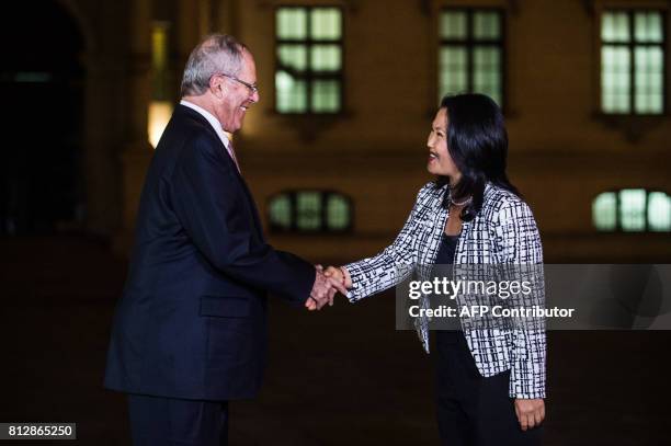 Peru's President Pedro Pablo Kuczynski shakes hands with the leader of Fuerza Popular party, Keiko Fujimori after a private meeting at the Peruvian...