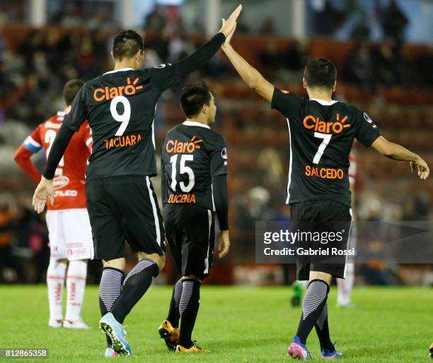 Santiago Salcedo of Libertad celebrates with teammate Oscar Cardozo after scoring the third goal of his team during a first leg match between Huracan...