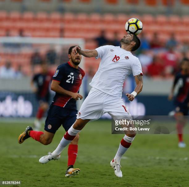 Steven Vitoria of Canada clears the ball away from Marco Urena of Costa Rica at BBVA Compass Stadium on July 11, 2017 in Houston, Texas.