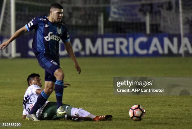 Player Alexis Ribera of Oriente Petrolero of Bolivia vies for the ball with David Barbona of Atletico Tucuman of Argentina during their Sudamericana...