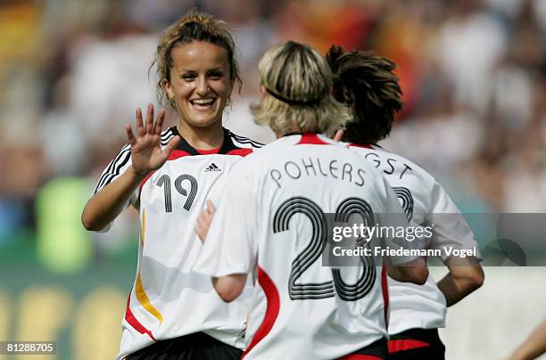 Conny Pohlers of Germany celebrates scoring the second goal with Fatmire Bajramaj during the Women's Euro 2009 qualifier between Germany and Wales at...