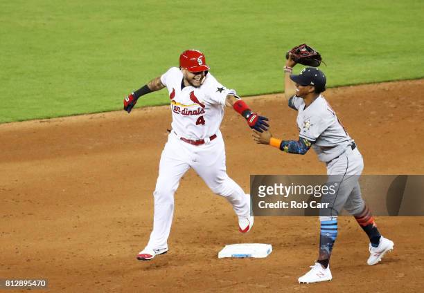 Yadier Molina of the St. Louis Cardinals and the National League jokes with Francisco Lindor of the Cleveland Indians and the American League as he...