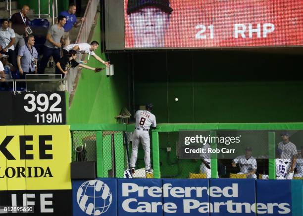 Justin Upton of the Detroit Tigers and the American League is unable to catch a solo home run ball hit by Yadier Molina of the St. Louis Cardinals...