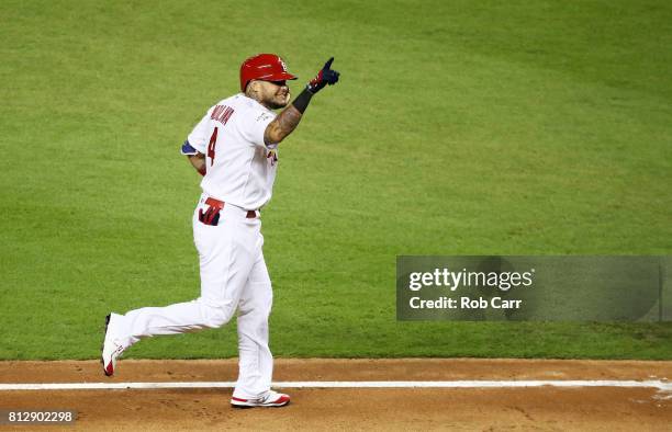 Yadier Molina of the St. Louis Cardinals and the National League celebrates after hitting a solo home run in the sixth inning against the American...