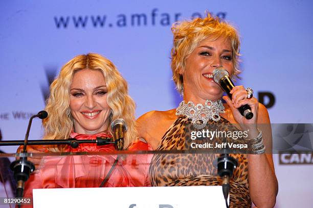 Singer Madonna and actress Sharon Stone speak during amfAR's Cinema Against AIDS 2008 audtion held at Le Moulin de Mougins during the 61st...