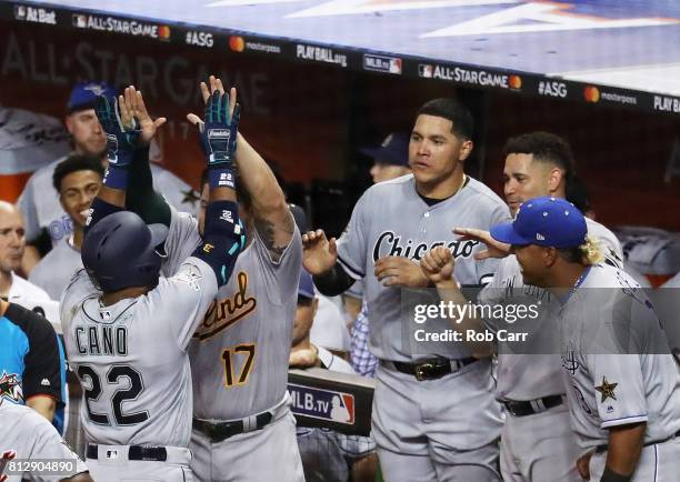 Robinson Cano of the Seattle Mariners and the American League celebrates with teammates after hitting a home run in the tenth inning against the...