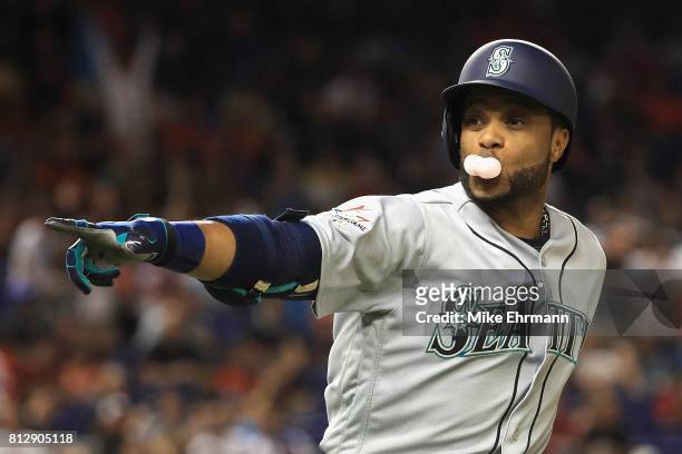 Robinson Cano of the Seattle Mariners and the American League celebrates hitting a home run in the tenth inning against the National League during...