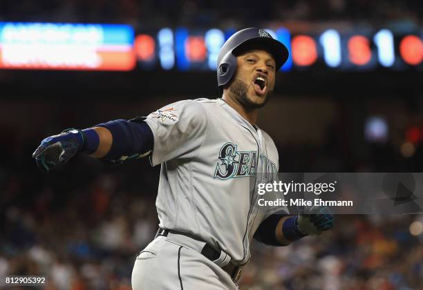 Robinson Cano of the Seattle Mariners and the American League celebrates hitting a home run in the tenth inning against the National League during...