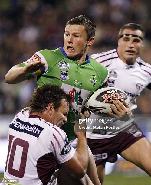 Todd Carney of the Raiders is tackled during the round 12 NRL match between the Canberra Raiders and the Manly Warringah Sea Eagles at Canberra...