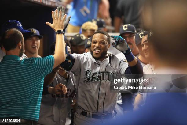 Robinson Cano of the Seattle Mariners and the American League celebrates with teammates after hitting a home run in the tenth inning against the...