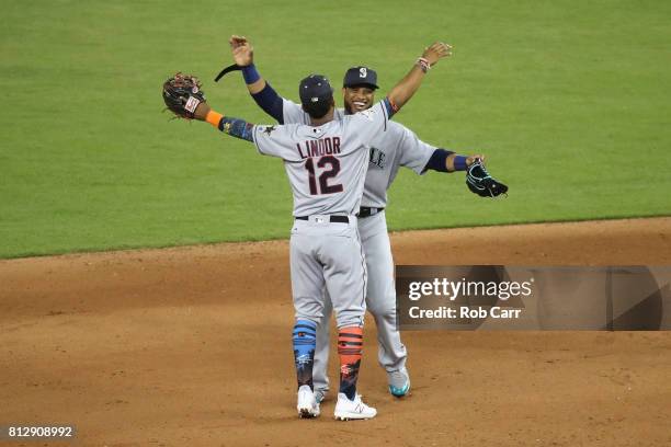 Robinson Cano of the Seattle Mariners and the American League and Francisco Lindor of the Cleveland Indians and the American League celebrate...