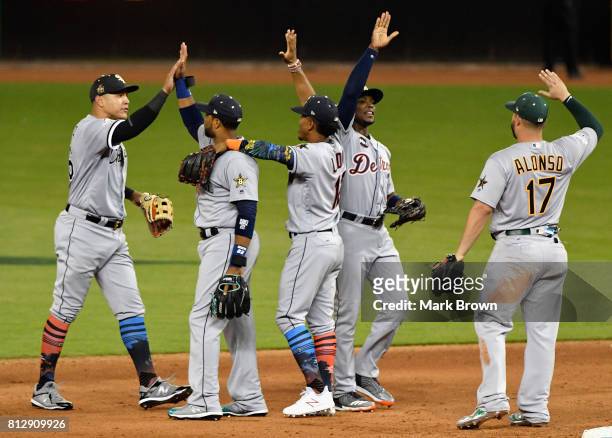 Robinson Cano of the Seattle Mariners and the American League celebrates with teammates after they defeated the National League 2 to 1 during the...