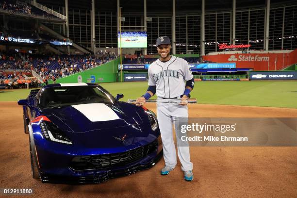 Robinson Cano of the Seattle Mariners and the American League celebrates with the Major League Baseball All-Star Game Most Valuable Player Award...