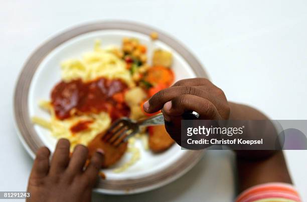 Child eats lunch at the Wuppertal Tafel on May 30, 2008 in Wuppertal-Barmen, Germany. Unicef, United Nation's Children's Fund reports an alarming...