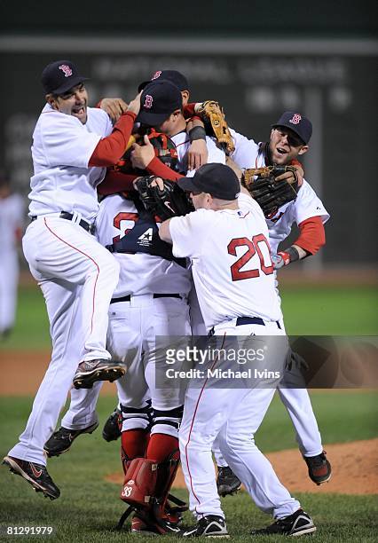 Jon Lester of the Boston Red Sox is greeted by joyful teammates after pitching a no-hitter against the Kansas City Royals at Fenway Park in Boston,...