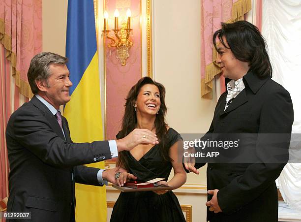 President of Ukraine Viktor Yushchenko holds the hand of Ukrainian singer Ani Lorak who took second place in the Eurovision Song Contest 2008 in...