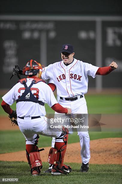 Jon Lester of the Boston Red Sox is greeted by catcher Jason Varitek after pitching a no-hitter against the Kansas City Royals at Fenway Park in...