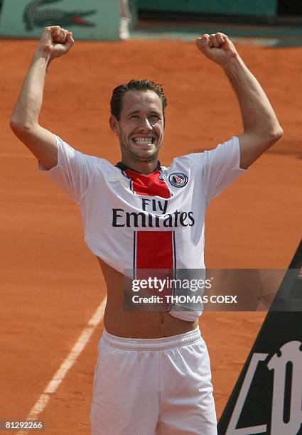 French player Michael Llodra wearing a jersey of French soccer club PSG reacts after beating Italian player Simone Bolelli during the third round of...