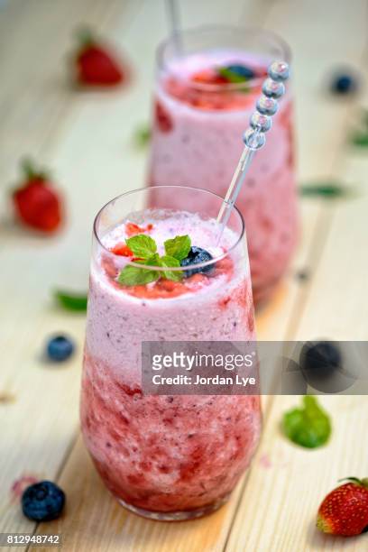 two berry smoothies - strawberry smoothie stock pictures, royalty-free photos & images