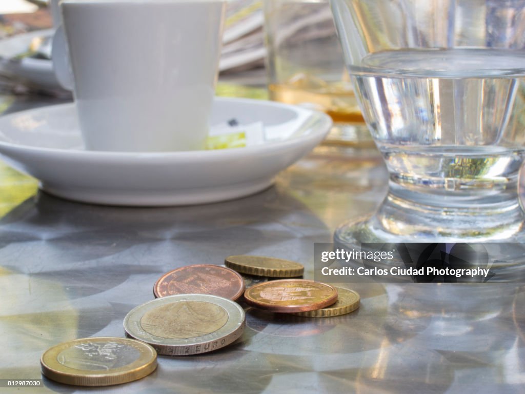 Close-up of euro coins on table in a Spanish restaurant