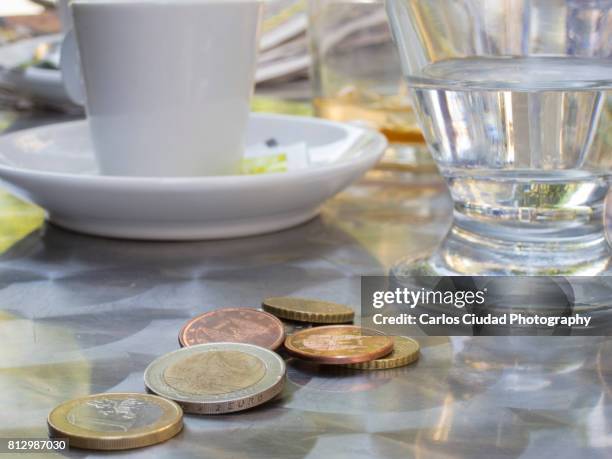 close-up of euro coins on table in a spanish restaurant - gratuity - fotografias e filmes do acervo