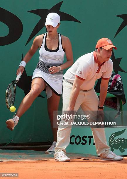 Czech player Petra Cetkovska picks up a ball prior to serve to her compatriot Iveta Benesova during their French tennis Open third round match at...