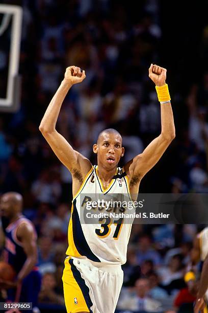 Reggie Miller of the Indiana Pacers holds his arms in the air in Game Four of the Eastern Conference Finals against the New York Knicks during the...
