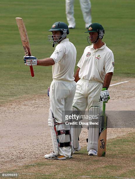 Simon Katich of Australia celebrates reaching his half-century as team-mate Ricky Ponting looks on during day one of the Second Test match between...