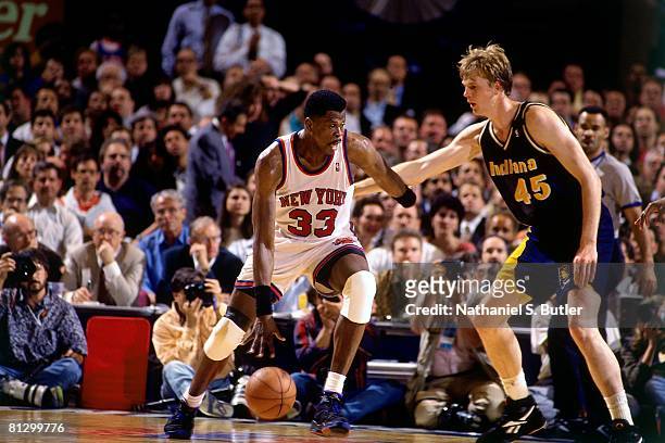 Patrick Ewing of the New York Knicks moves the ball against Rick Smits of the Indiana Pacers in Game Five of the Eastern Conference Finals during the...