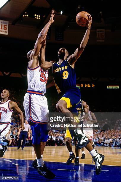 Derrick McKey of the Indiana Pacers shoots a layup against Charles Smith of the New York Knicks in Game Five of the Eastern Conference Finals during...