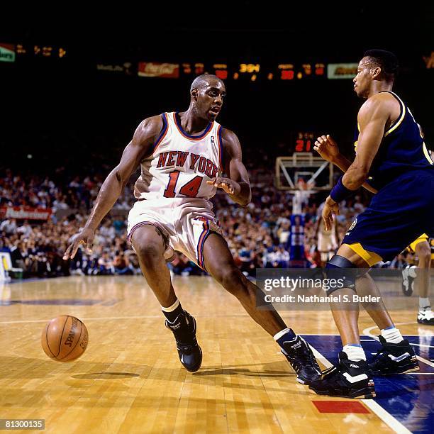 Anthony Mason of the New York Knicks moves the ball against Byron Scott of the Indiana Pacers in Game Seven of the Eastern Conference Finals during...